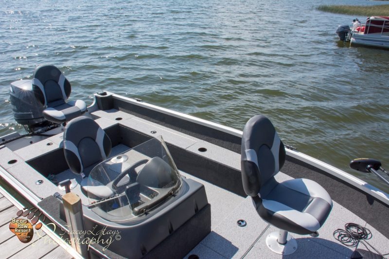 Fishing boat docked on calm lake water
