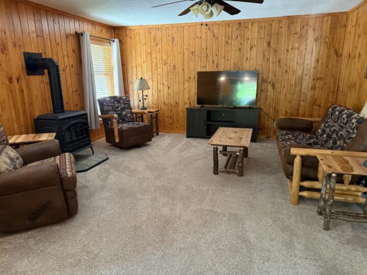 Rustic living room with wood stove and TV