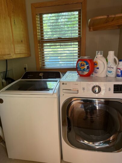 Laundry room with washer, dryer, and detergents