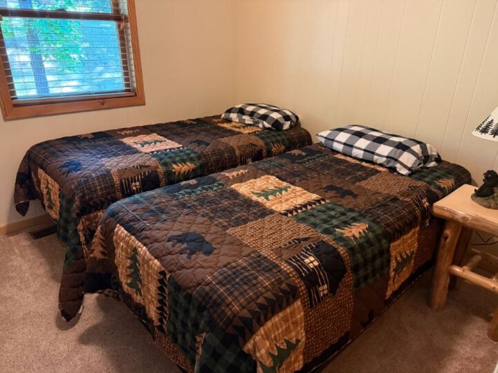 Two twin beds with rustic patchwork quilts