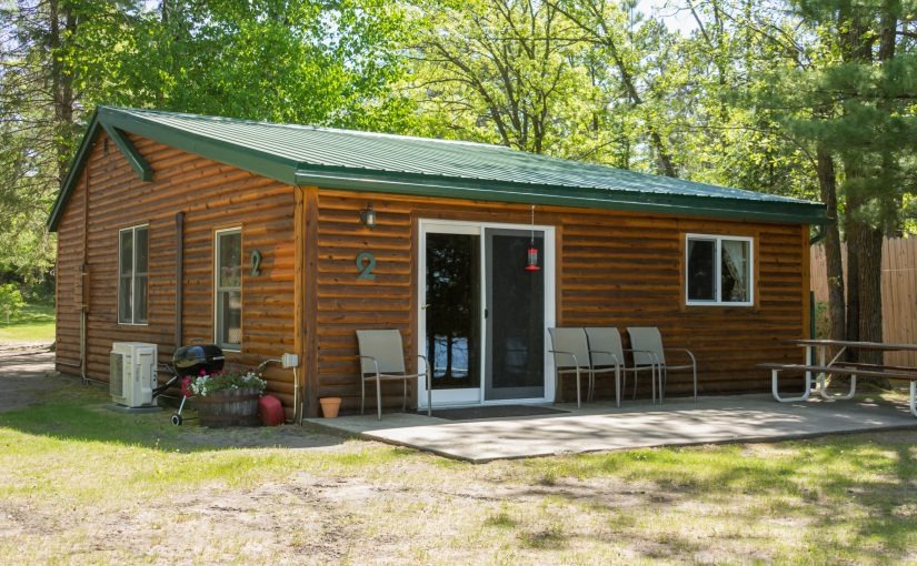 Cozy log cabin with green metal roof