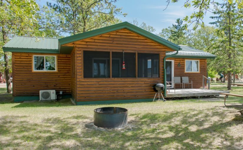 Wooden cabin with screened porch and fire pit