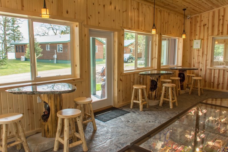 Rustic wooden cafe interior with stools and windows